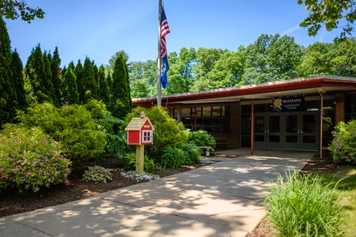 Braeburn Elementary School a building with a flag pole and a flagpole